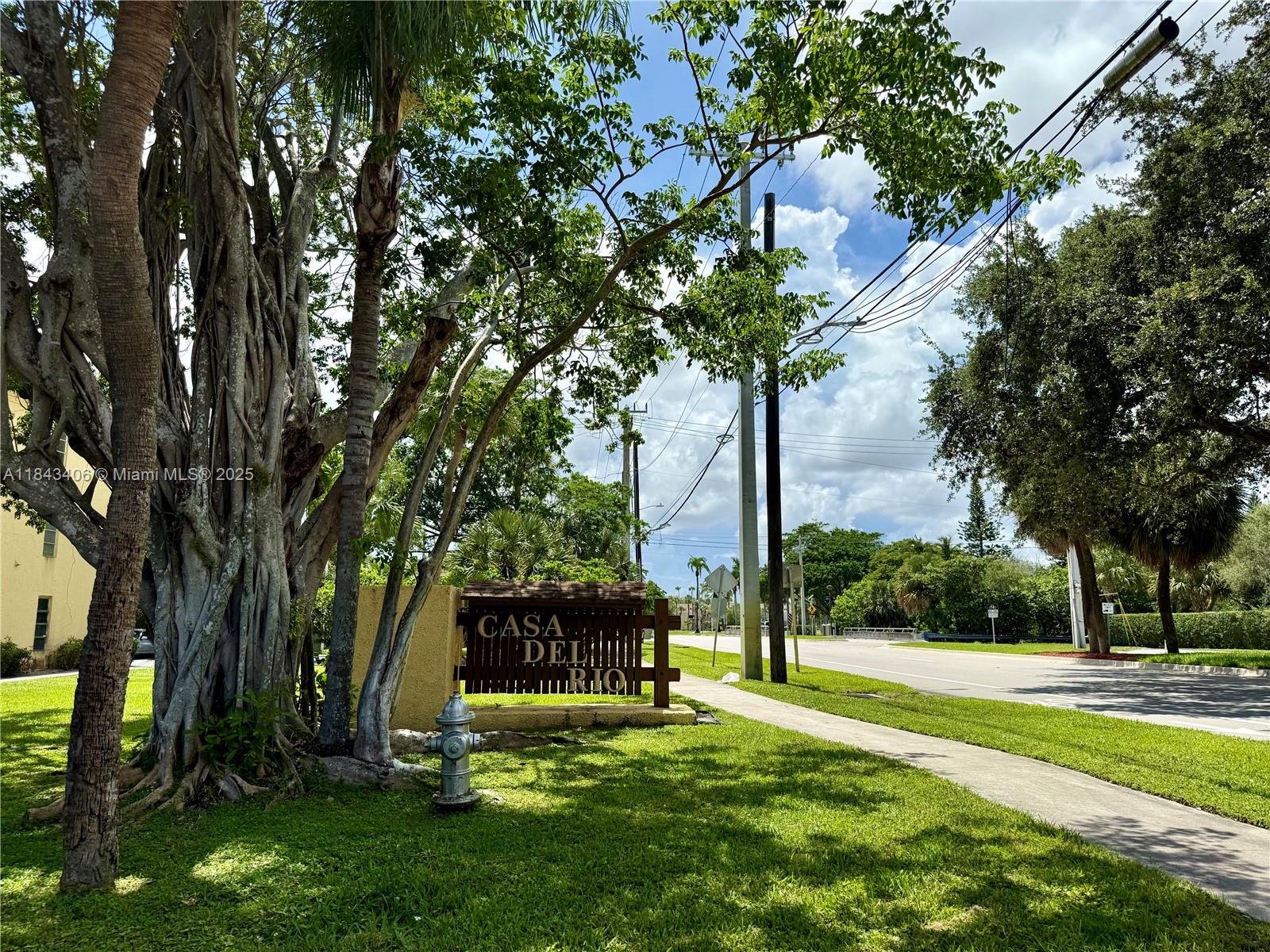 480 Northwest 20th Street, Unit 207 Boca Raton, FL 33431 - Photo 24 of 26 a view of a tree in front of a house