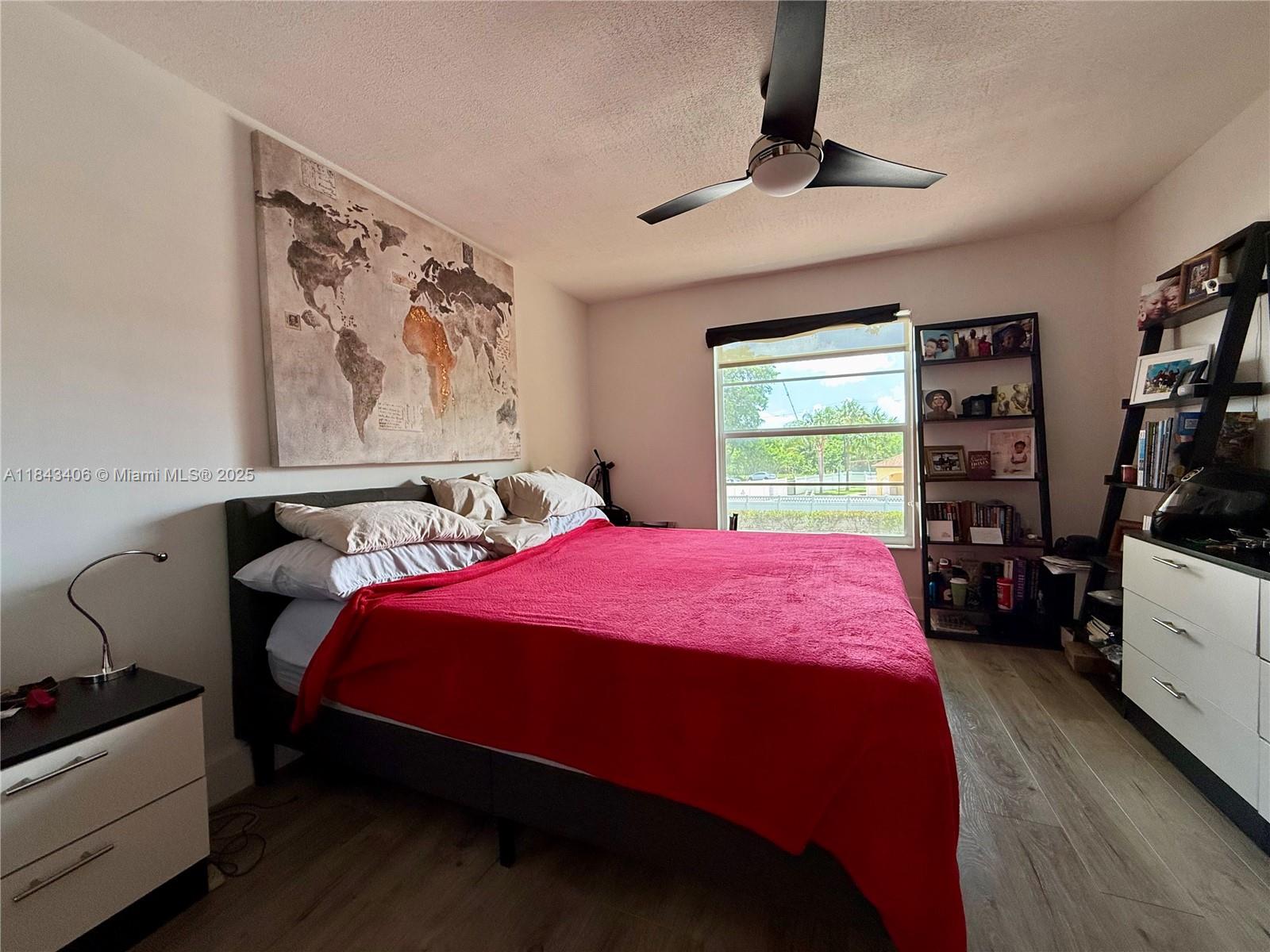 480 Northwest 20th Street, Unit 207 Boca Raton, FL 33431 - Photo 8 of 26 a bedroom with a bed and a chandelier