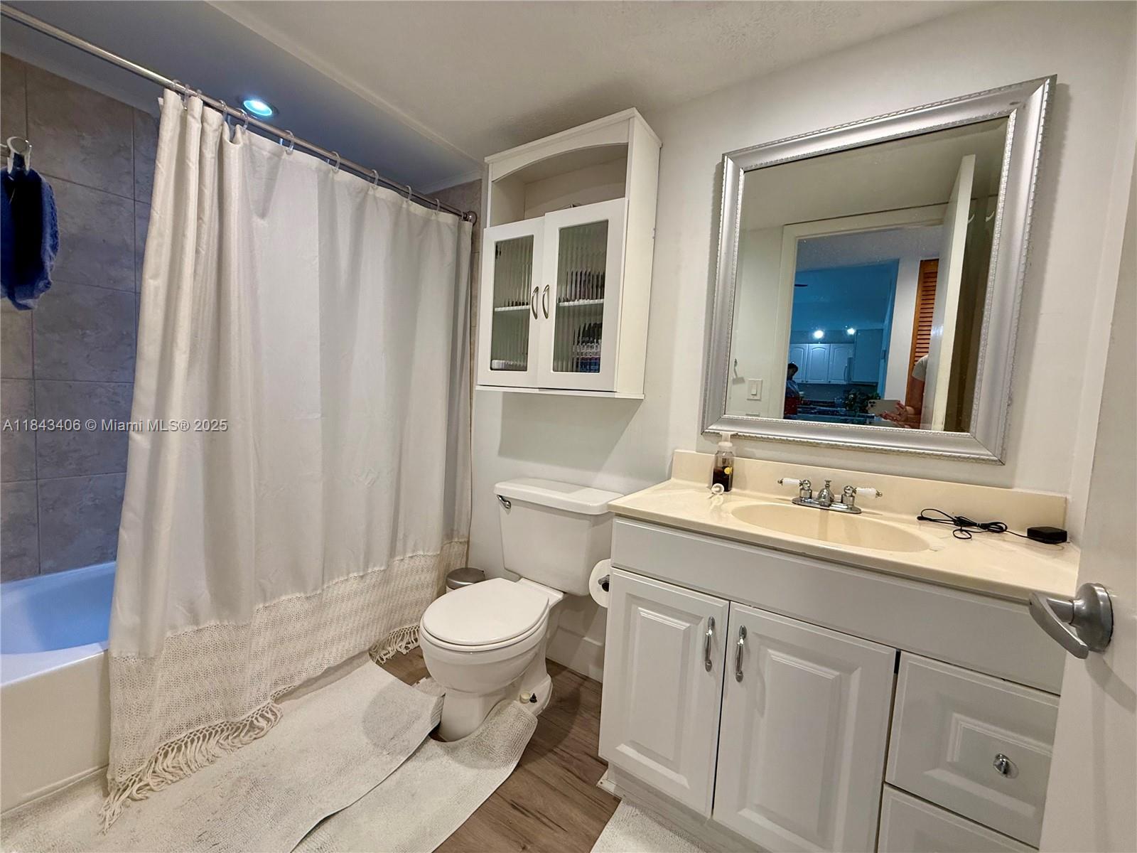 480 Northwest 20th Street, Unit 207 Boca Raton, FL 33431 - Photo 10 of 26 a bathroom with a sink a toilet and shower