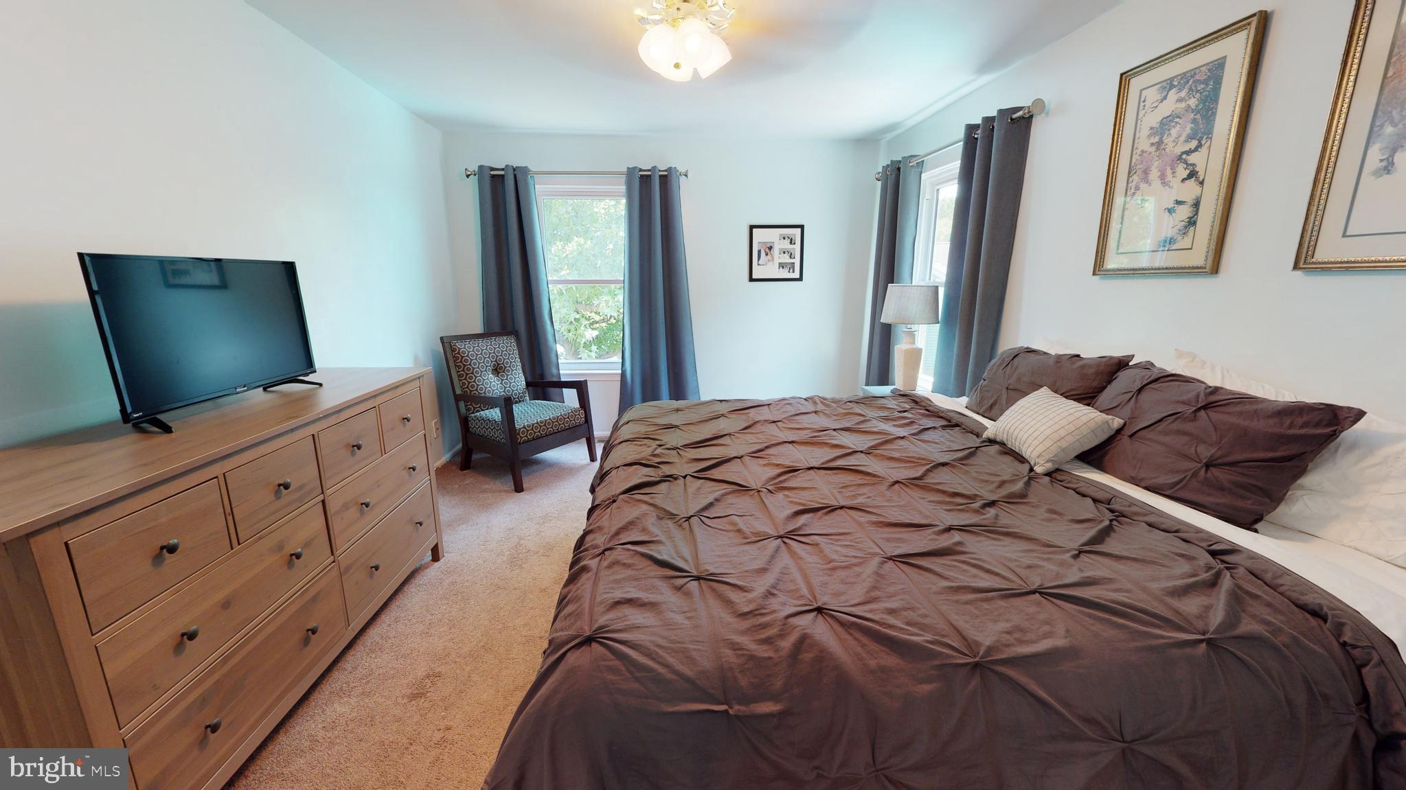 5 Carlton Avenue Evesham, NJ 08053 - Photo 26 of 33 a bedroom with a large bed and a flat tv screen on dresser