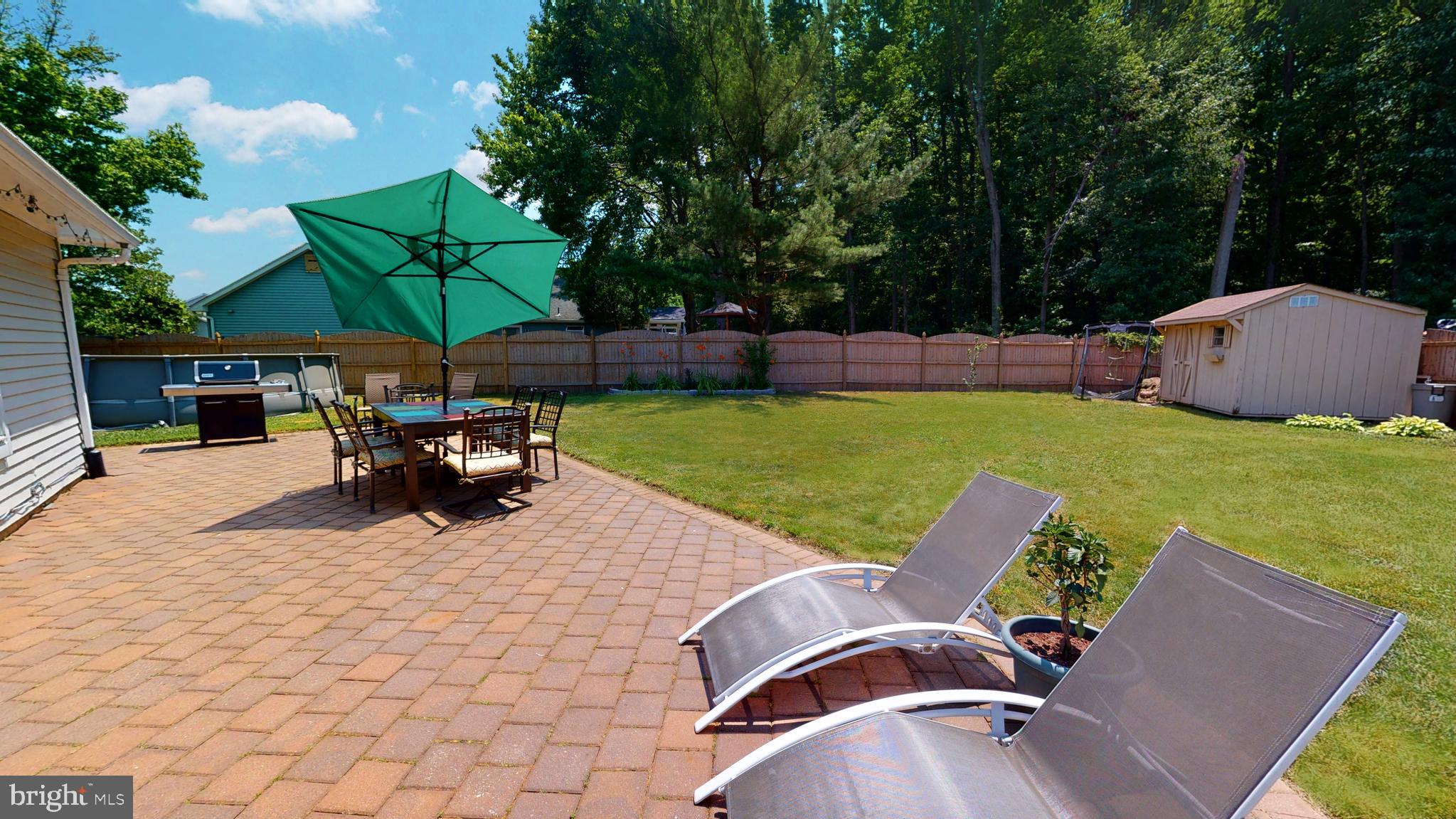 5 Carlton Avenue Evesham, NJ 08053 - Photo 29 of 33 an outdoor sitting area with furniture and umbrella