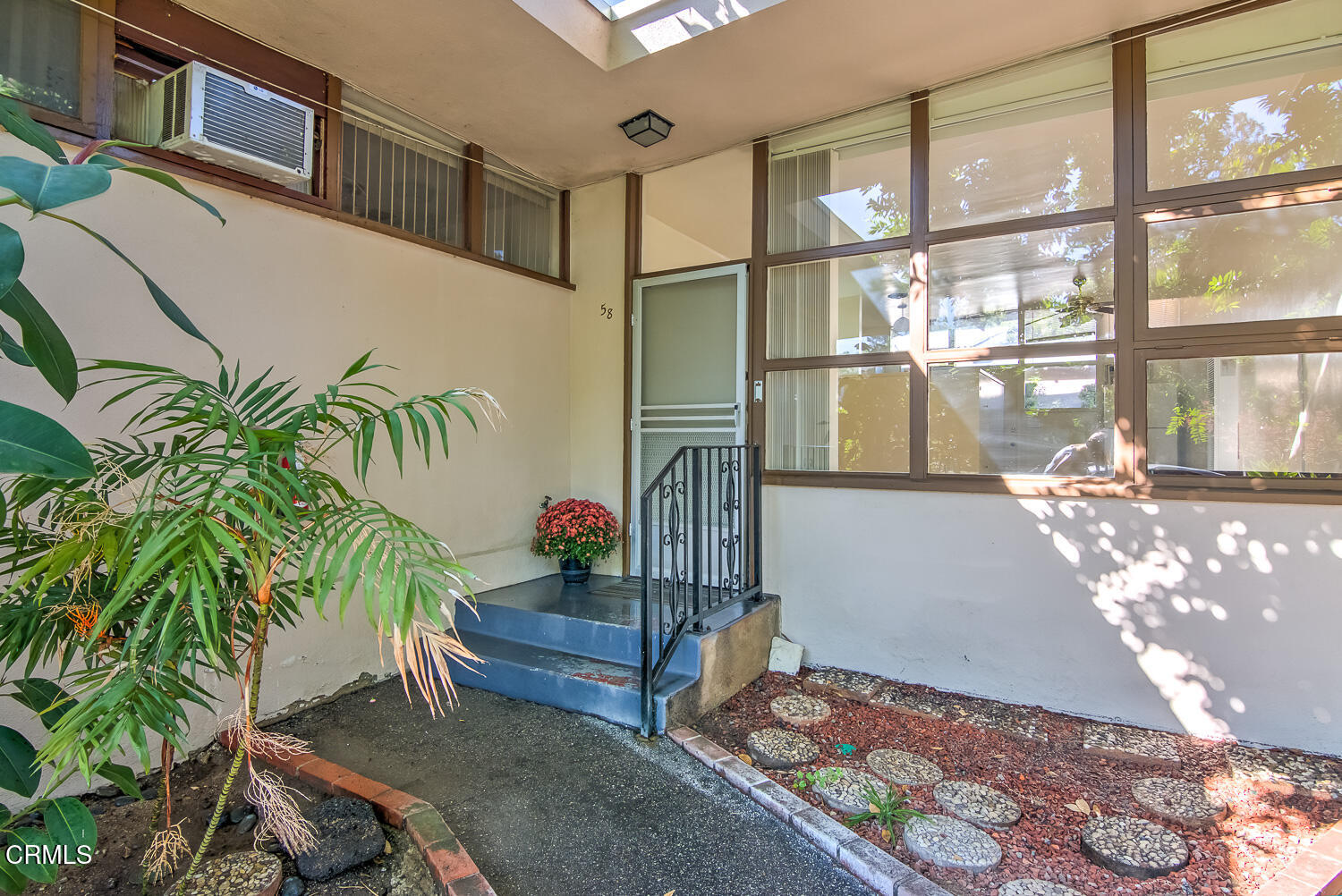 58 Avenue 64 Pasadena, CA 91105 - Photo 2 of 10 a room with potted plants and a large tree
