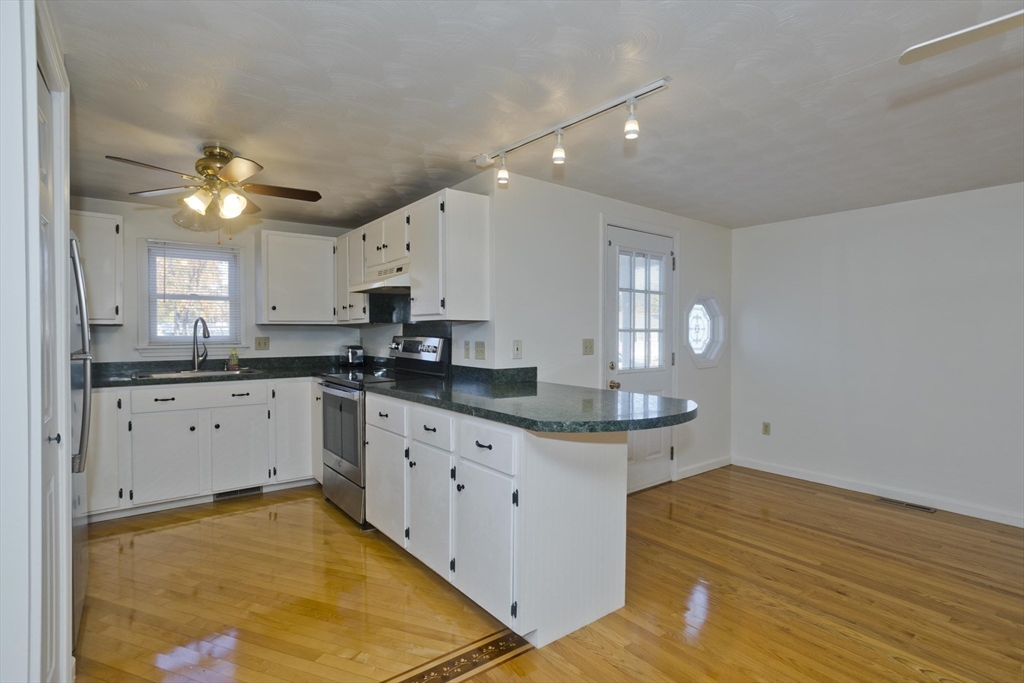 22 Pine View Three Rivers, MA 01080 - Photo 3 of 25 a kitchen with granite countertop a stove a sink and a refrigerator