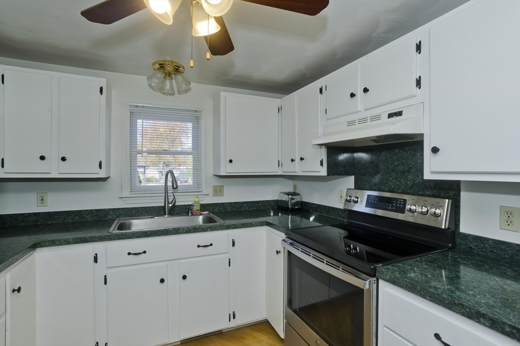 22 Pine View Three Rivers, MA 01080 - Photo 7 of 25 a kitchen with granite countertop a sink a stove and cabinets