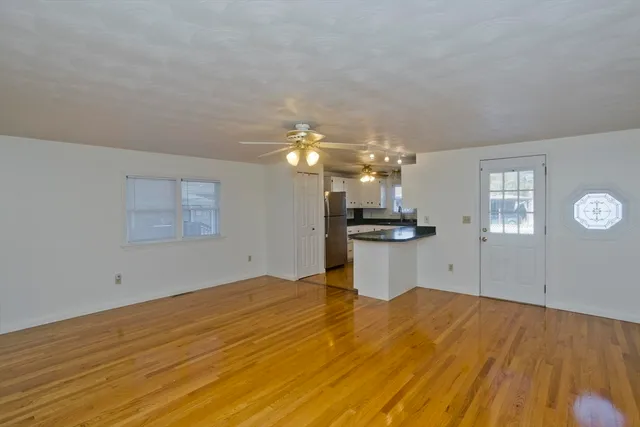 a view of a room with a window and wooden floor