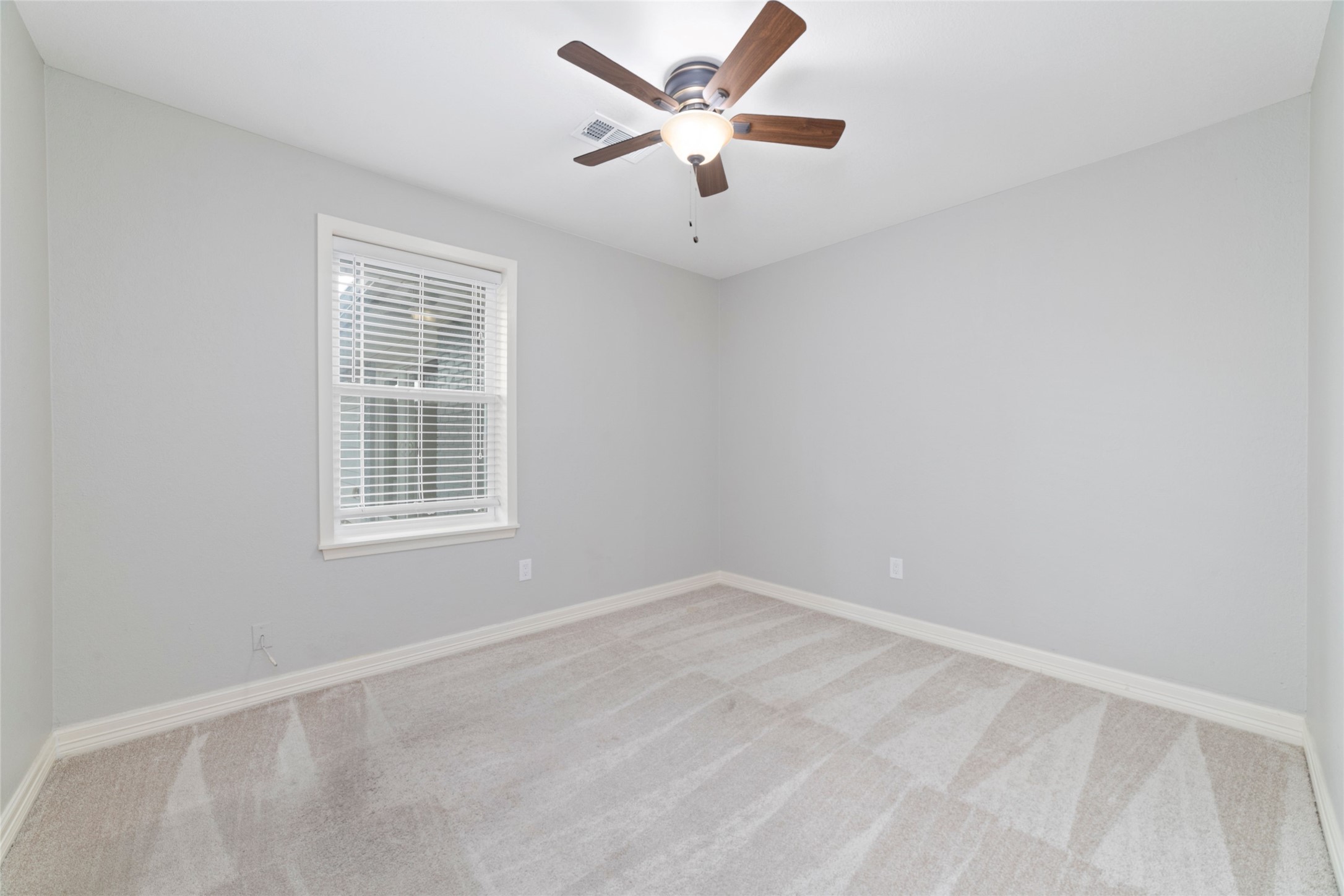 3815 April Lane Houston, TX 77092 - Photo 26 of 33 an empty room with windows and fan