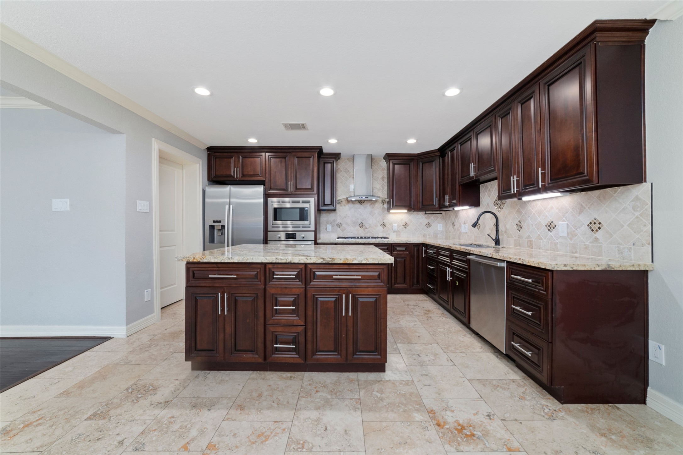 3815 April Lane Houston, TX 77092 - Photo 8 of 33 a kitchen with stainless steel appliances granite countertop wooden cabinets a stove a sink and a oven