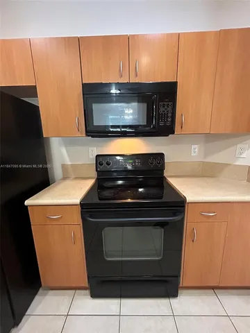 a stove top oven sitting inside of a kitchen