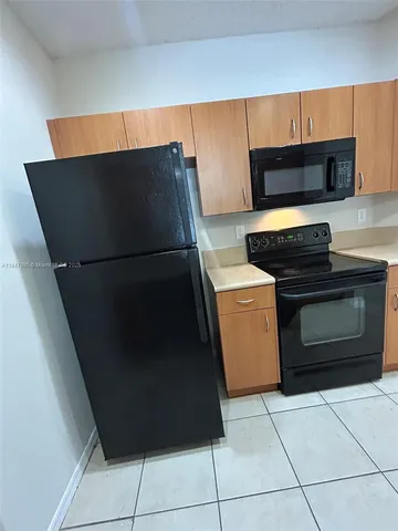 a kitchen with a stove and a refrigerator