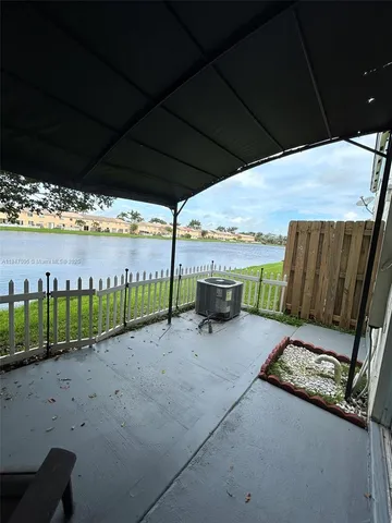 a view of an empty room with a chandelier fan
