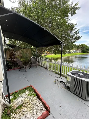 a view of an empty room with a chandelier fan