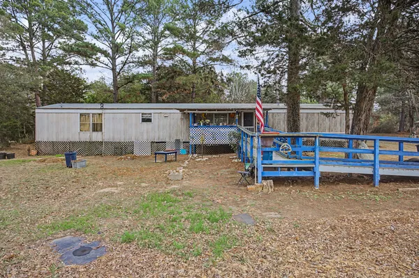 a backyard of a house with barbeque oven table and chairs