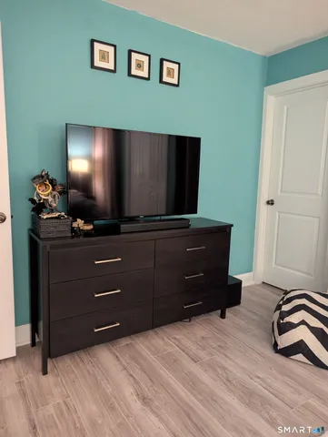 a room with a bed and television