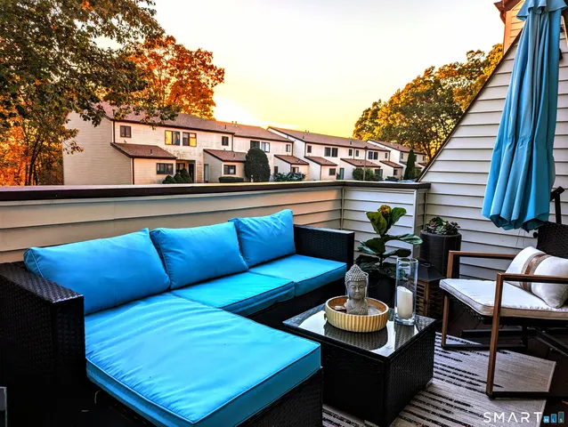 a roof deck with a table and chairs