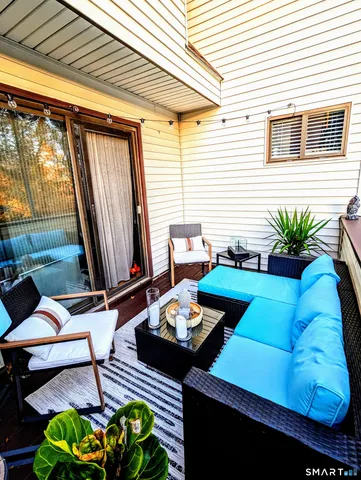 a view of a patio with table and chairs and potted plants