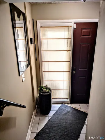 a bedroom with bed couch and window