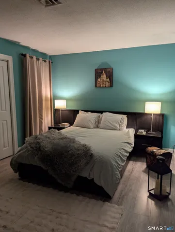 a bedroom with a bed and a television