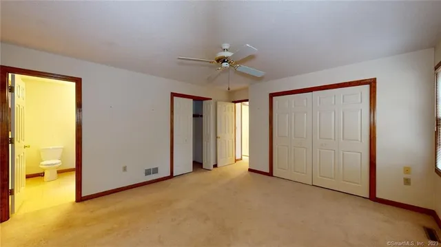 an empty room with windows and closet