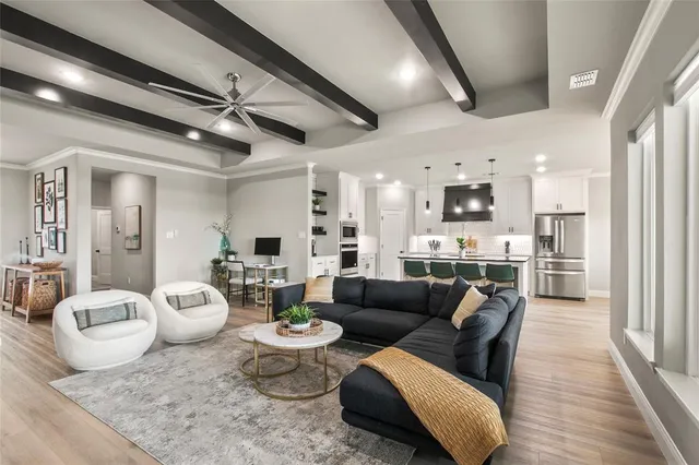 a living room with furniture and kitchen view