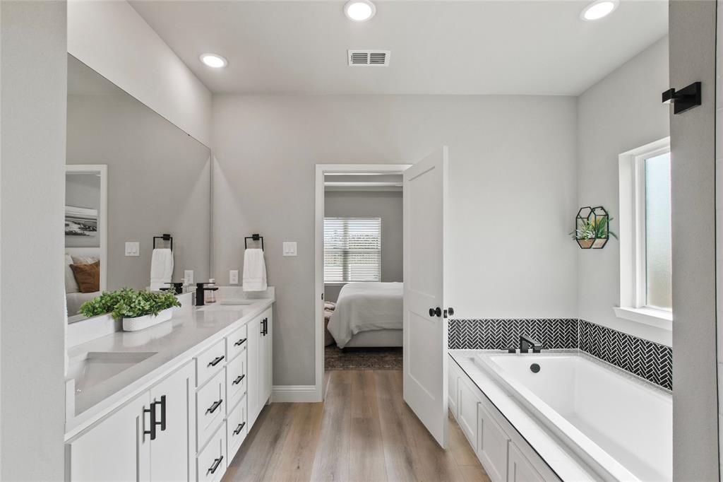 80 Dublin Circle Gordonville, TX 76245 - Photo 16 of 39 a spacious bathroom with double vanity sinks and a bathtub