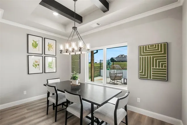 a dining room with furniture a chandelier and window