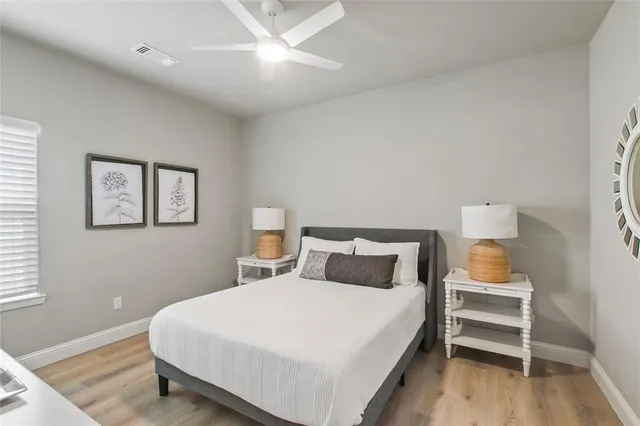 a bedroom with a bed and a lamp