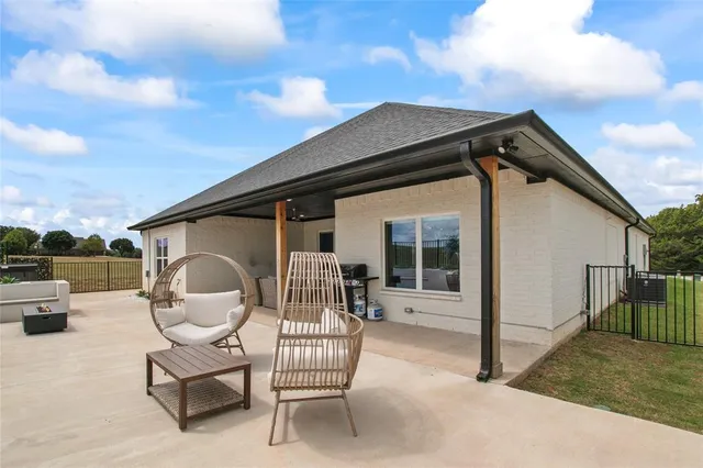 a patio with table and chairs