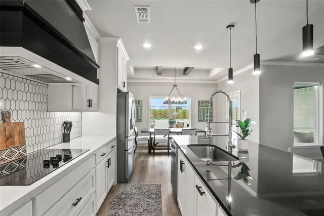 a kitchen with counter top space a sink and appliances