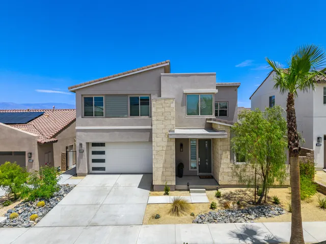 a living room with furniture and view of kitchen