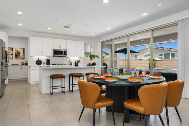 a kitchen with stainless steel appliances kitchen island granite countertop a sink counter space cabinets and a potted plant