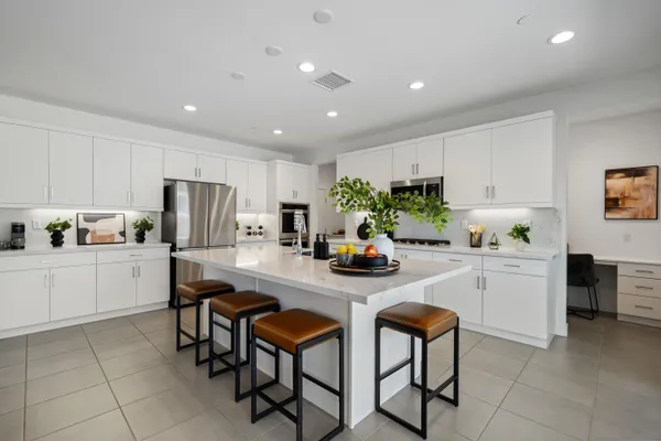 a group of people sitting in a kitchen