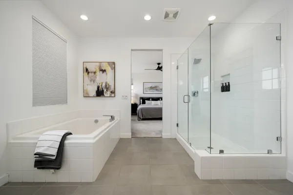 a bathroom with a bathtub shower sink vanity and toilet
