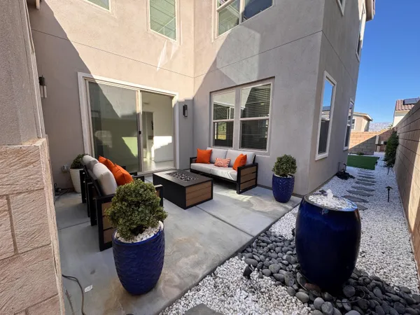 a swimming pool with outdoor seating and yard