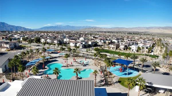 a spacious bedroom with a bed and a flat screen tv