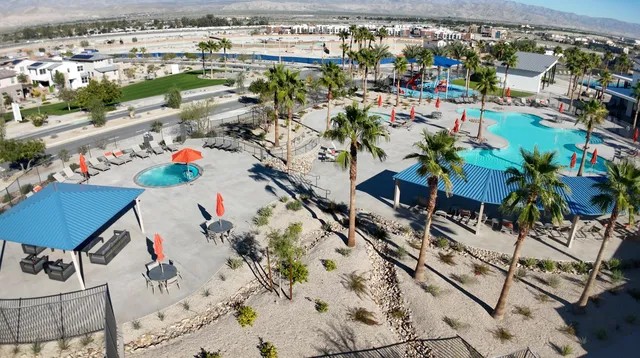 a living room with furniture a desk and a window