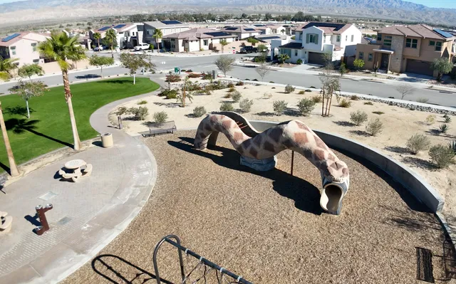 a view of a house with pool and chairs