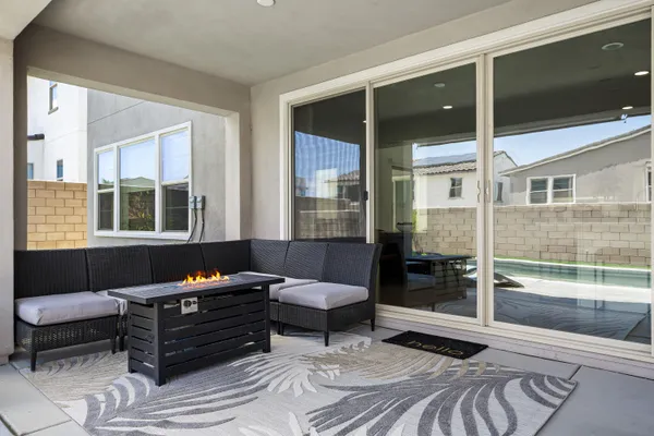 a view of a patio with a table and chairs under an umbrella
