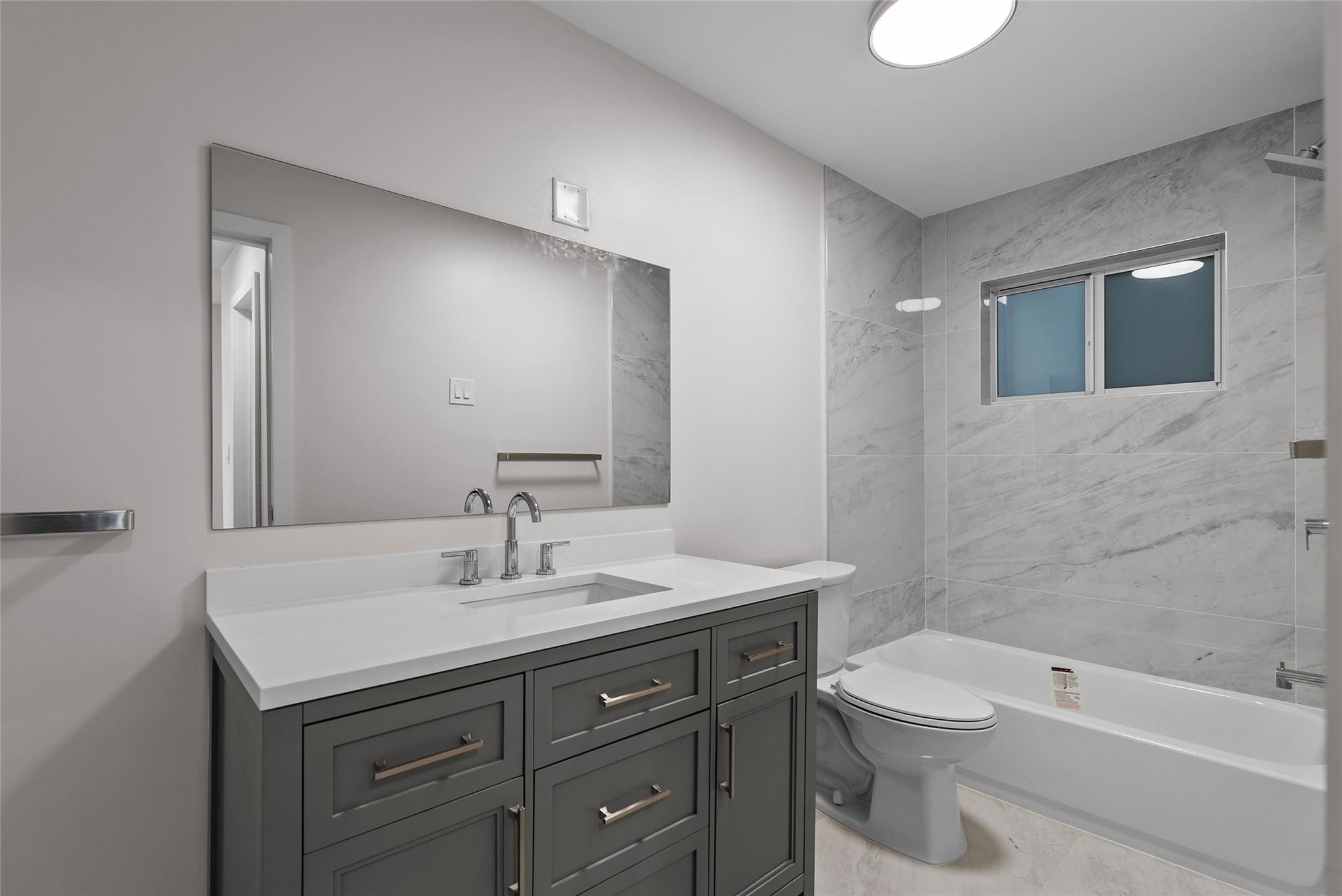 1150 East Sample Road, Unit 202 Pompano Beach, FL 33064 - Photo 14 of 20 a bathroom with a sink toilet and shower