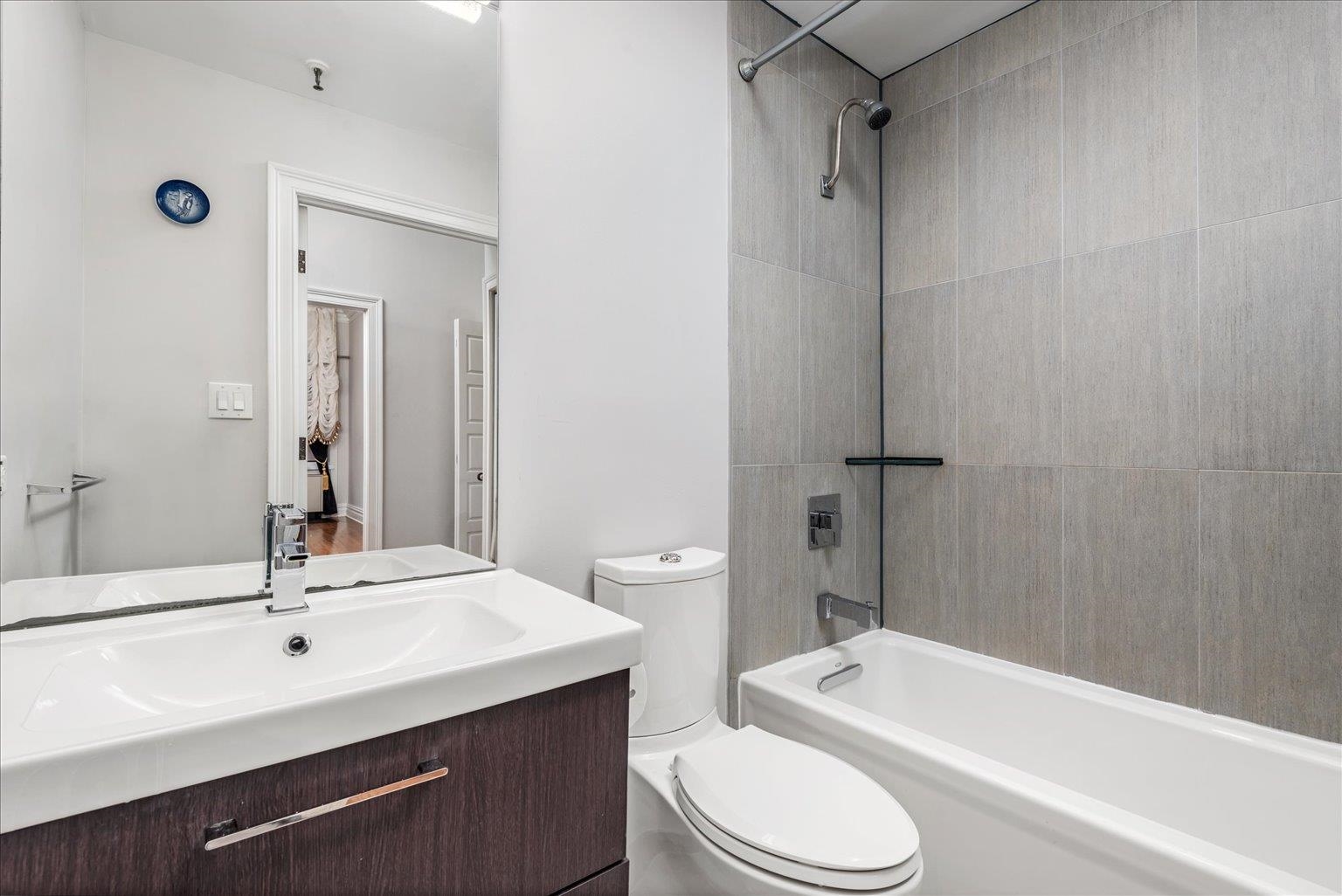 41-43 1st Street, Unit 1G Hoboken, NJ 07030 - Photo 13 of 26 a bathroom with a sink a toilet a mirror and shower