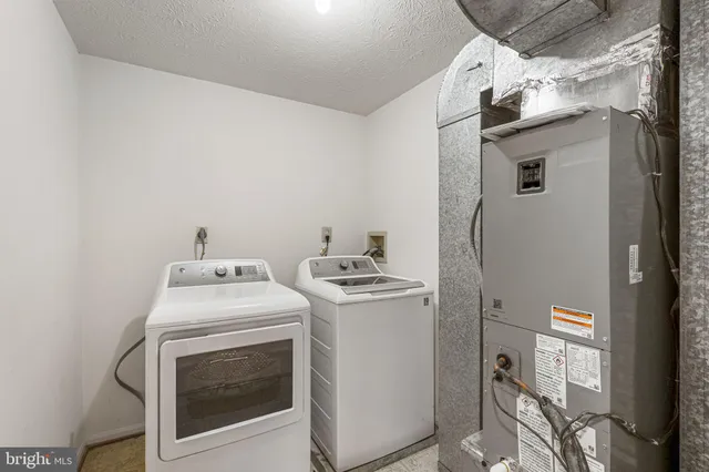 a view of an empty room with windows and chandelier