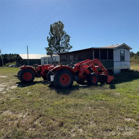 a view of a yard with a car parked in it