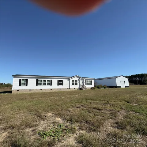 a view of a house with a tree
