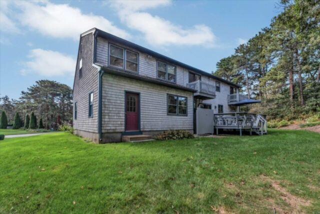 4 Surf Drive Mashpee, MA 02649 - Photo 19 of 22 a view of a house with a yard and sitting area