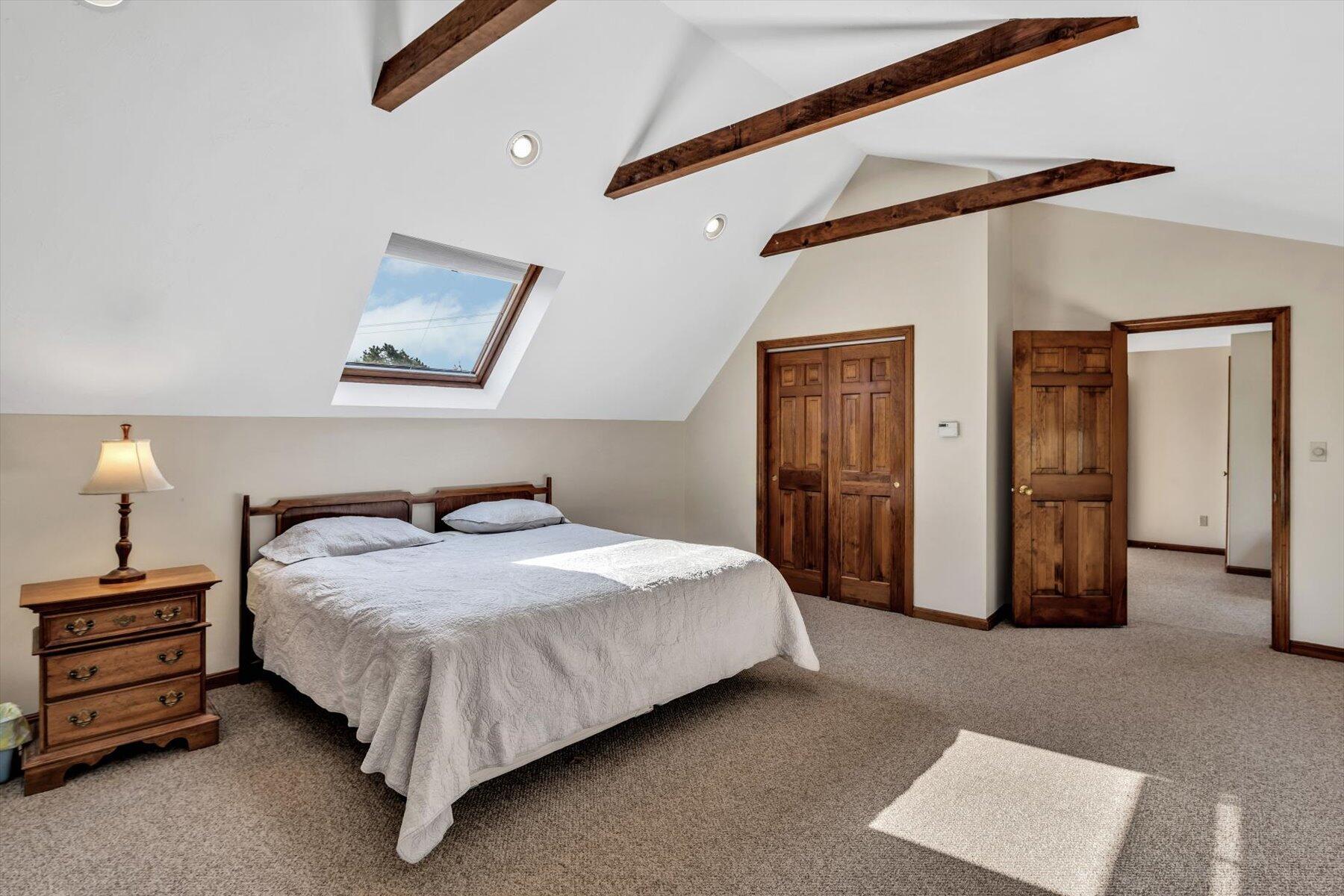 4 Surf Drive Mashpee, MA 02649 - Photo 9 of 22 a bedroom with a bed and a chandelier