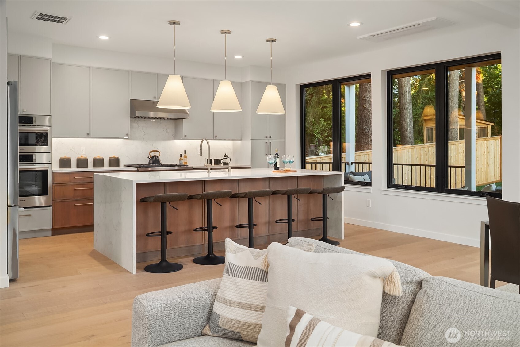6214 40th Avenue Northeast Seattle, WA 98115 - Photo 13 of 40 a large kitchen with stainless steel appliances kitchen island granite countertop a stove a sink a dining table and chairs