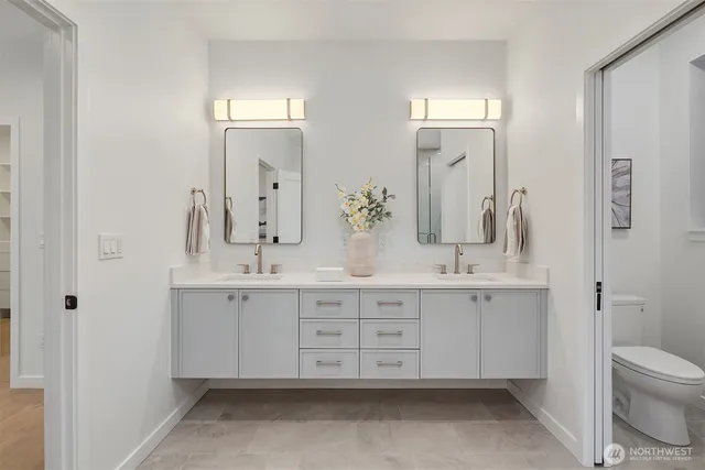 a bathroom with a double vanity sink and a mirror