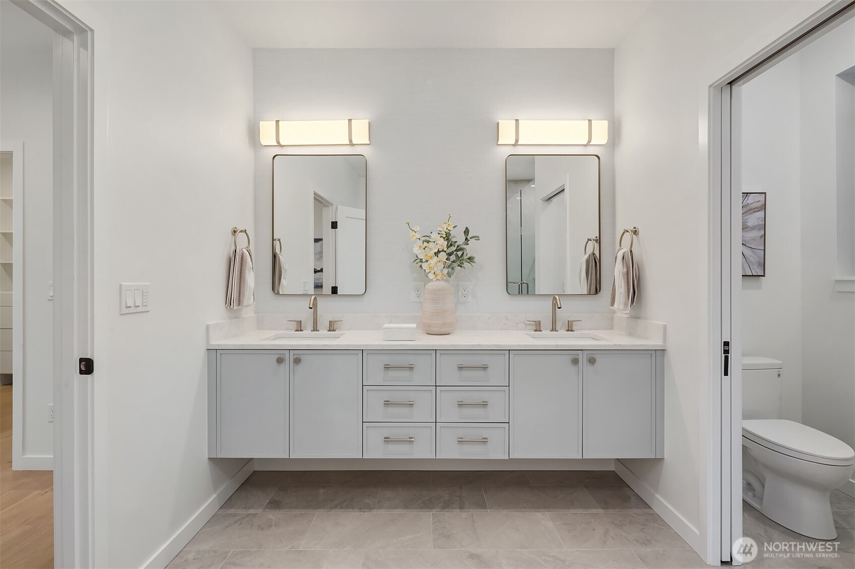 6214 40th Avenue Northeast Seattle, WA 98115 - Photo 26 of 40 a bathroom with double vanity sink a toilet and a mirror