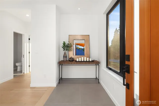 a living room with stainless steel appliances granite countertop furniture and a gate