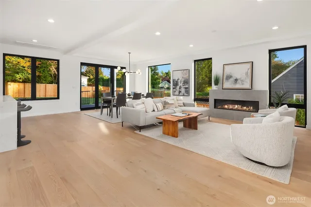 a living room with furniture large window and flat screen tv