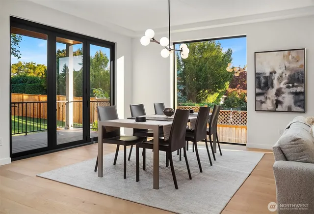 a dining room with furniture a flat screen tv and a large window